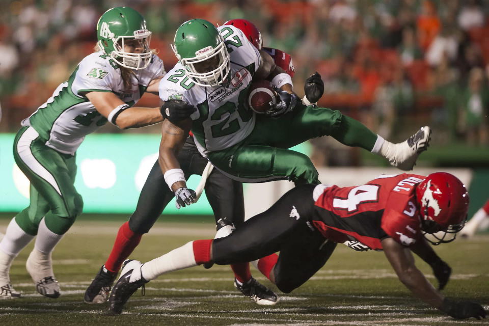 Saskatchewan Roughriders running back DeShawn Wynn is tackled during the second half of CFL pre-season football action against the Calgary Stampeders in Regina, Sask., Friday, June 22, 2012. The Stamps defeated the Riders 33-31. THE CANADIAN PRESS/Liam Richards