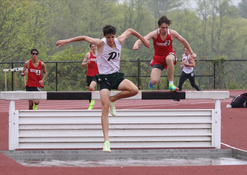 Theo Lynch from Pleasantville, center, placed first as Bryce Anderson from Tappan Zee, follows behind as athletes compete in the boys 3000 Meter Steeplechase during the Gold Rush Invitational Track & Field meet at Clarkstown South High School in West Nyack, April 29, 2023. 