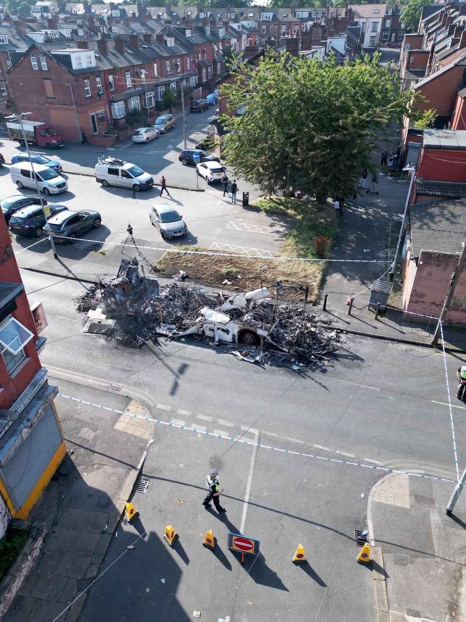 The remains of a burnt-out bus set alight (Getty Images)