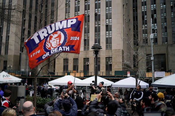 PHOTO: A supporter of former President Donald Trump waves a flag outside Manhattan Criminal Courthouse, on the day of Trump's planned court appearance after his indictment by a Manhattan grand jury in New York City, April 4, 2023. (Eduardo Munoz/Reuters)