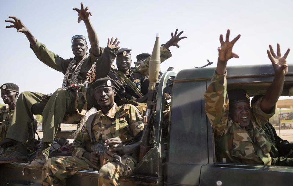 FILE - In this Sunday, Jan 12, 2014 file photo, South Sudanese government forces from the "Lion division" cheer their recent victory, after government forces on Friday retook from rebel forces the provincial capital of Bentiu, in Unity State, South Sudan. South Sudan's government and rebels fighting against it have signed Thursday, Jan. 23, 2014 a cessation of hostilities agreement in Addis Ababa that should at the least put a pause to five weeks of warfare that has claimed thousands of lives and uprooted a half million people since fighting began Dec. 15 between the government and supporters of former Vice President Riek Machar. (AP Photo/Mackenzie Knowles-Coursin, File)