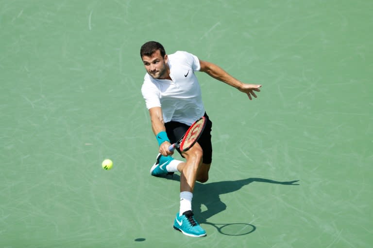 Grigor Dimitrov of Bulgaria hits a return to Stan Wawrinka of Switzerland, in Mason, Ohio, on August 18, 2016