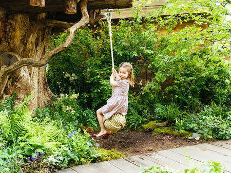 FILE PHOTO: Britain's Princess Charlotte plays on a rope swing at the Adam White and Andree Davies co-designed garden ahead of the RHS Chelsea Flower Show in London, Britain. May 19, 2019. Matt Porteous/PA Wire/Handout via REUTERS/File Photo