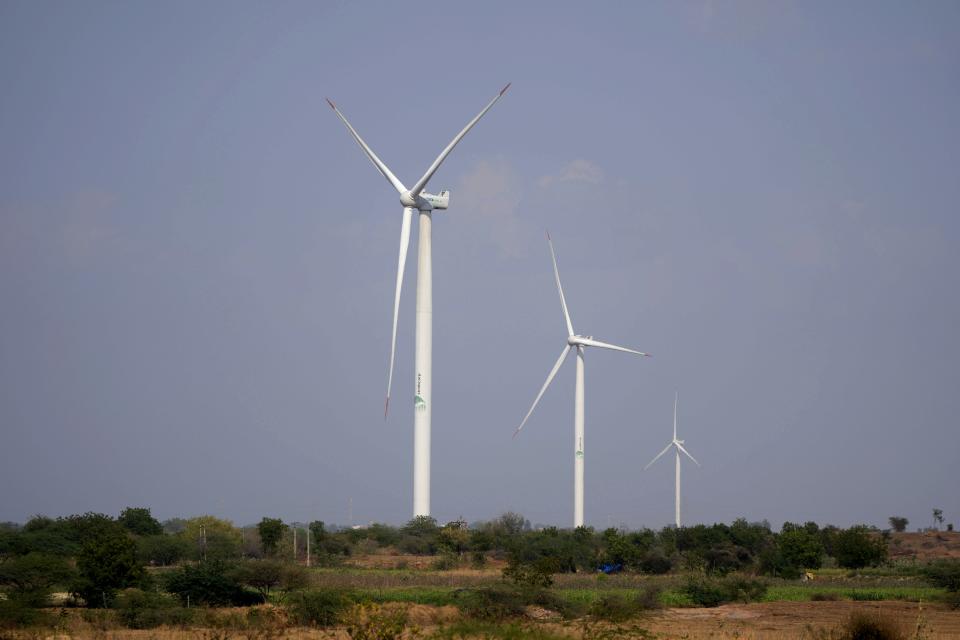 Wind turbines, an Adani Group project, work near Sadla village in Surendranagar district of Gujarat state, India, Monday, March 20, 2023. Gautam Adani and his companies lost tens of billions of dollars and the stock for his green energy companies have plummeted. Despite Adani's renewable energy targets accounting for 10% of India's clean energy goals, some analysts say Adani's woes won't likely hurt India's energy transition. (AP Photo/Ajit Solanki)