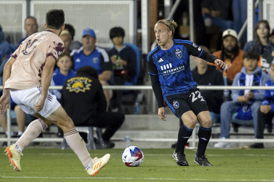 San Jose Earthquakes defender Tommy Thompson (22) looks to pass the ball past Portland Timbers defender Eric Miller (15) during the second half of an MLS soccer match in San Jose, Calif., Saturday, June 17, 2023. The game ended in a scoreless draw. (AP Photo/John Hefti)