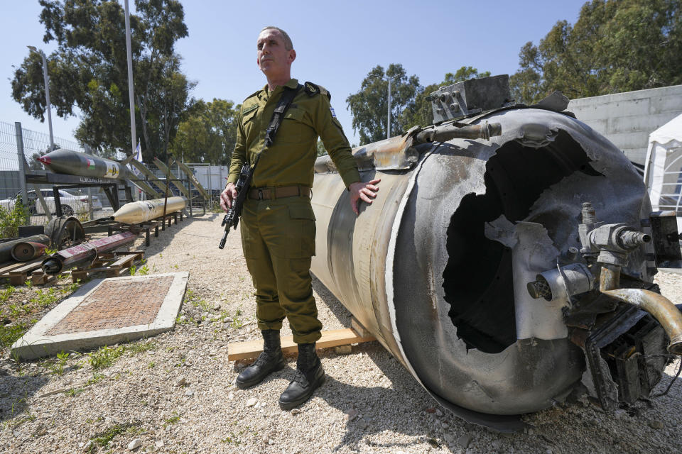 Israeli military spokesperson, Rear Adm. Daniel Hagari, display to the media one of the Iranian ballistic missiles Israel intercepted over the weekend, in Julis army base, southern Israel, Tuesday, April 16, 2024. Israel says that Iran launched over 300 missiles and attack drones in the weekend attack. It says most of the incoming fire was intercepted, but a handful of missiles landed in Israel, causing minor damage and wounding a young girl. (AP Photo/Tsafrir Abayov)