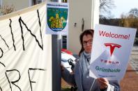 A demonstrators holds pro-Tesla poster during an action to support plans by U.S. electric vehicle pioneer Tesla to build its first European factory and design center in Gruenheide