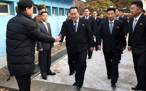 The head of North Korean delegation Ri Son-Gwon (C) crosses a border line to attend a meeting at the Panmunjom truce village last week - Credit: Getty