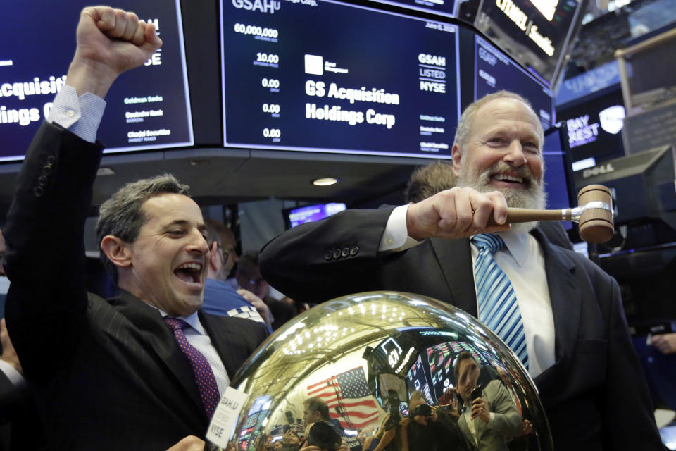 GS Acquisition Holdings Corp. CEO David Cote, right, rings a ceremonial bell on the floor of the New York Stock Exchange, as his company's IPO begins trading, Friday, June 8, 2018. At left is NYSE Vice President Chris Taylor. (AP Photo/Richard Drew)