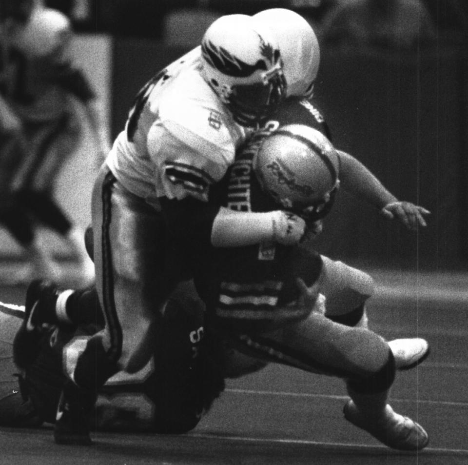 In a game June 21, 1992, Cincinnati Rockers quarterback Art Schlichter is taken down by Albany's Rodney Smith at then Riverfront Coliseum.
