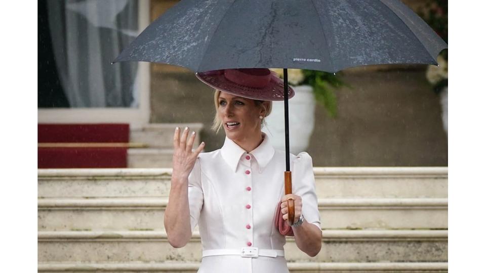 Zara Tindall in white button down shirt dress with pink hat at Buckingham Palace 