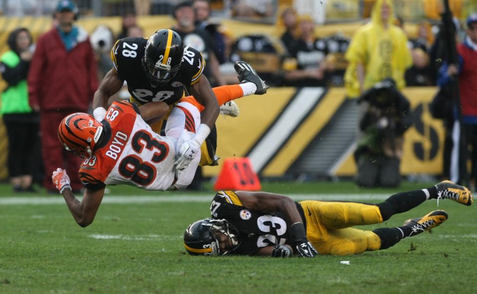 <p>Cincinnati Bengals wide receiver Tyler Boyd (83) is tackled by Pittsburgh Steelers safety Sean Davis (28) and safety Mike Mitchell (23) during the second half at Heinz Field. The Steelers won the game, 24-16. Mandatory Credit: Jason Bridge-USA TODAY Sports </p>