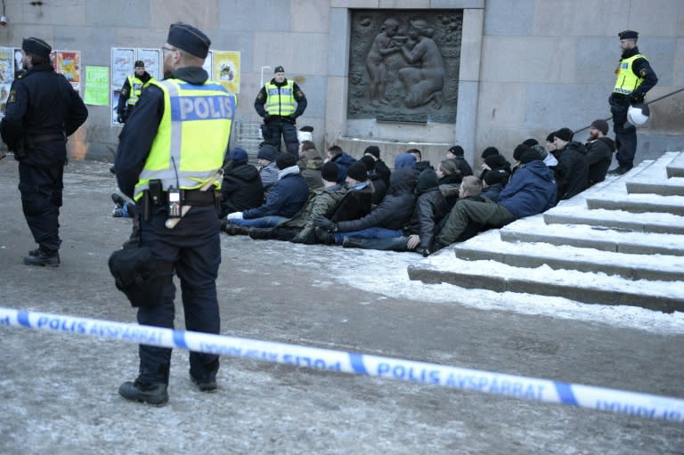 Swedish police surround an arrested group of neo-Nazis after they staged a rally in Stockholm in January