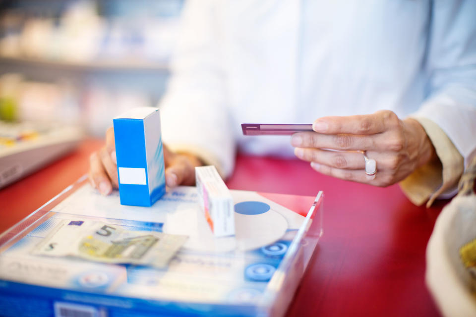 A pharmacist holding someone's card