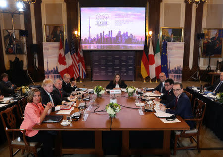 Canada's Minister of Foreign Affairs Chrystia Freeland is joined by France's Minister of Europe and Foreign Affairs Jean-Yves Le Drian, Acting U.S. Secretary of State John J. Sullivan, Britain's Foreign Secretary Boris Johnson, High Representative for the European Union's Foreign Affairs Federica Mogherini, Italy's Minister of Foreign Affairs Angelino Alfano, Japan's Minister of Foreign Affairs Taro Kono and Minister of Foreign Affairs for Germany Heiko Maas at opening remarks on the first day of foreign ministers meetings from G7 countries in Toronto, Ontario, Canada April 22, 2018. REUTERS/Fred Thornhill