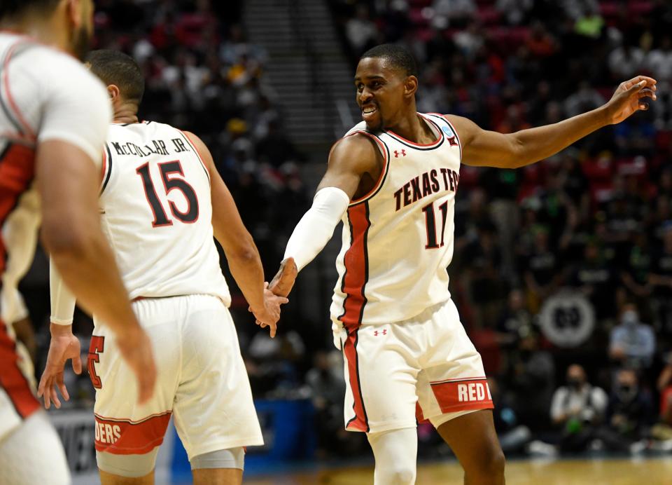 Texas Tech's Bryson Williams (11) high-fives Texas Tech's Kevin McCullar (15) at the NCAA tournament's second round game against Notre Dame, Sunday, March 20, 2022, at Viejas Arena in San Diego, California. Texas Tech won, 59-53.