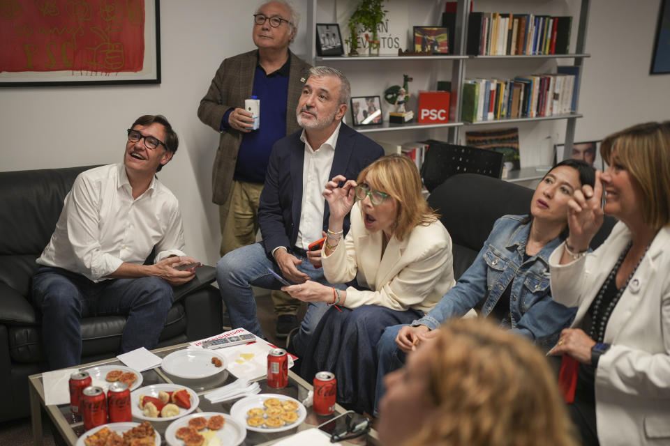 Socialist candidate Salvador Illa, left, watches early results on TV with other members of the PSC ( Socialist Party of Catalonia ) at the party headquarters in Barcelona, Sunday May 12, 2024. The Socialists led by former health minister Illa won a majority of 42 seats, up from their 33 seats in 2021 when they also barely won the most votes but were unable to form a government. They will still need to earn the backing of other parties to put Illa in charge.(AP Photo/Emilio Morenatti)