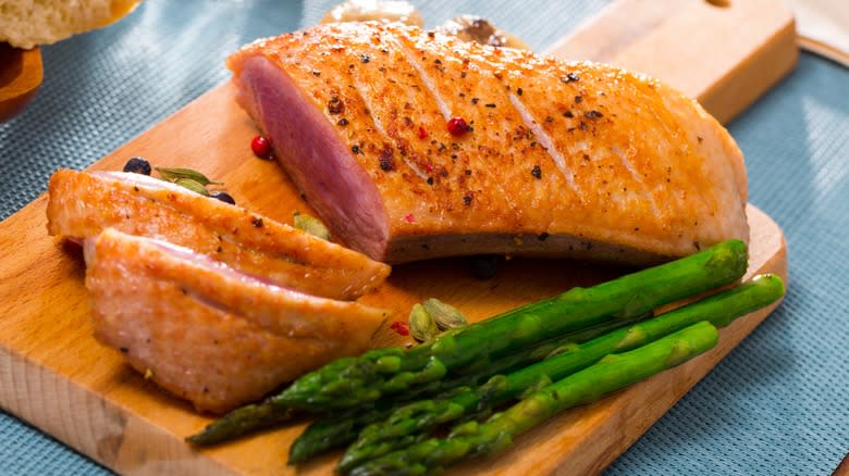 duck breast on wooden board 