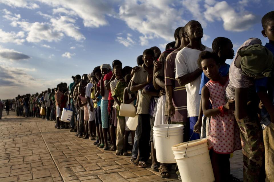 People wait in long lines for crackers and water in Port-au-Prince.