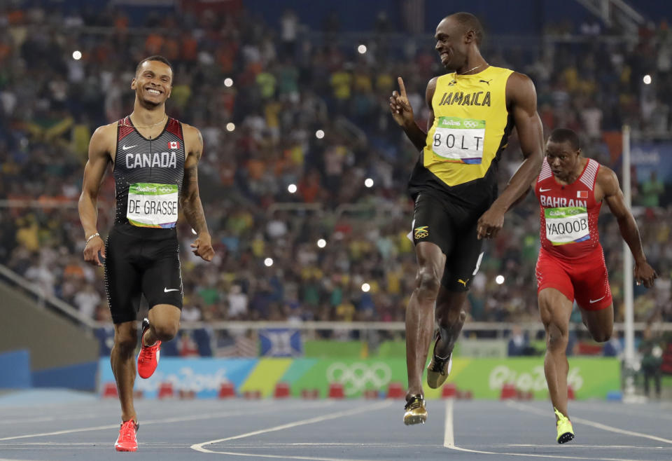 FILE - Jamaica's Usain Bolt, right, gestures towards Canada's Andre De Grasse after the finish of the men's 200-meter semifinal during the athletics competitions of the 2016 Summer Olympics at the Olympic stadium in Rio de Janeiro, Brazil, Aug. 17, 2016. De Grasse didn't beat Bolt at the Rio Games in 2016. But he made a name for himself when he had the audacity to push the Jamaican to the line in the 200-meter semifinal, a move that forced Bolt to crank back up after he'd started slowing down, then left the Jamaican great wagging his finger at De Grasse when they crossed. (AP Photo/David J. Phillip, File)