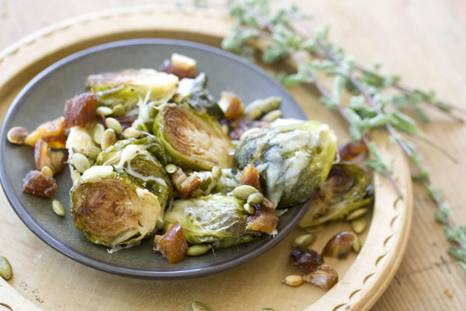 This Oct. 14, 2013 photo shows Gruyere roasted brussels sprouts with pepitas and dates in Concord, N.H. (AP Photo/Matthew Mead)