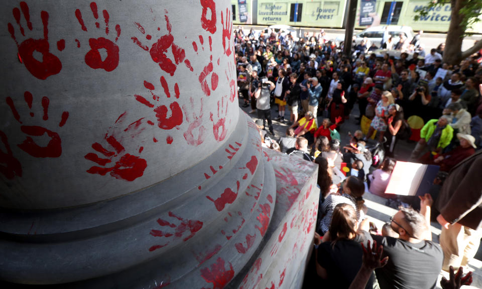 Protestors leave red paint hand prints on a pillar during a protest outside the South Australian Parliament in Adelaide, Wednesday, November 13, 2019. Aboriginal and Torres Strait Islander communities and allies are calling for justice for 19-year-old Warlpiri teenager Kumanjayi Walker, who died after being shot by police on Saturday night in the central desert town of Yuendumu in the Northern Territory. (AAP Image/Kelly Barnes) NO ARCHIVING