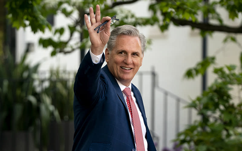 House Minority Leader Kevin McCarthy (R-Calif.) waves at reporters as he leaves a closed-door House Republican Conference meeting at the Capitol Hill Club on April 27. <em>Greg Nash</em>