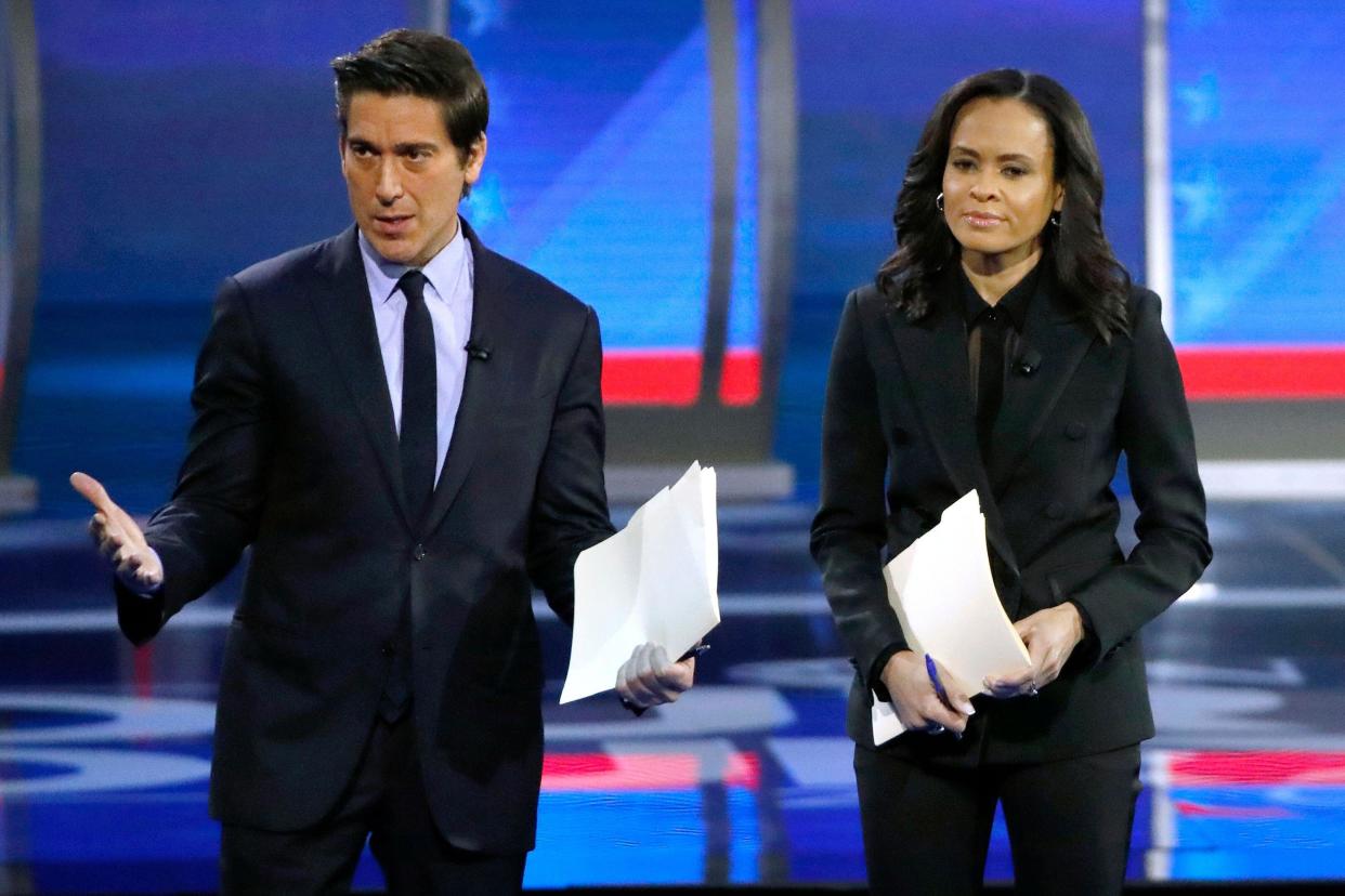 FILE - ABC World News Tonight Anchor David Muir, left, addresses members of the audience while standing with ABC News Live Anchor Linsey Davis, Friday, Feb. 7, 2020 in Manchester, N.H. (AP Photo/Elise Amendola, File)