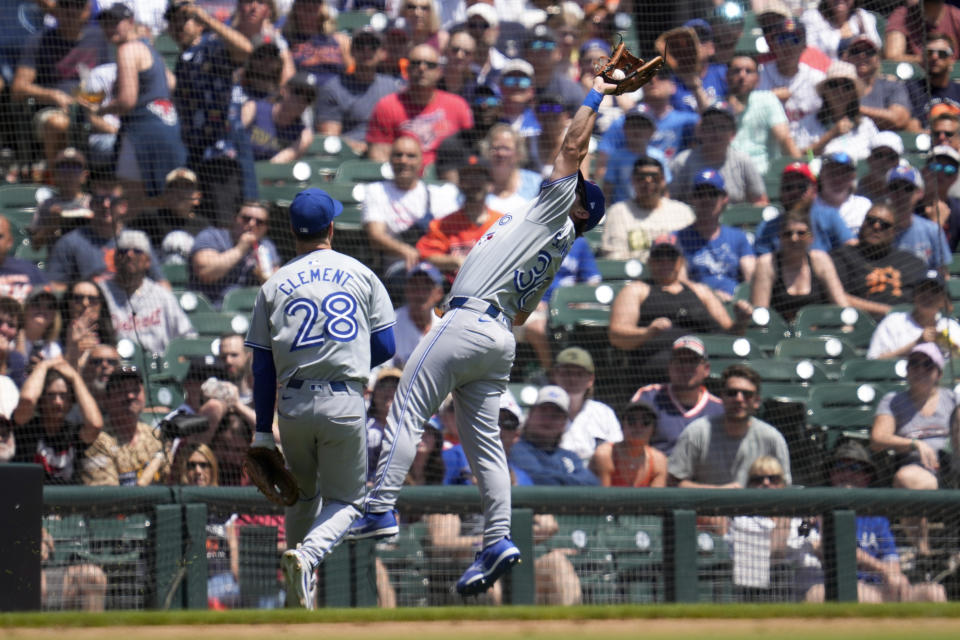 Toronto Blue Jays outfielder Davis Schneider (36) catches a Detroit Tigers' Colt Keith fly ball in foul territory as Ernie Clement (28) looks on in the fourth inning of a baseball game, Saturday, May 25, 2024, in Detroit. (AP Photo/Paul Sancya)