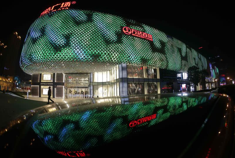 A man walks in front of an entrance to a Wanda Department Store in Wuhan, Hubei province, in this December 23, 2014 file photo. REUTERS/Stringer/Files