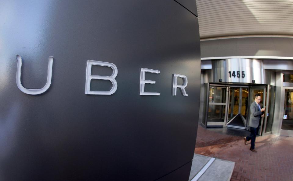 FILE - In this Dec. 16, 2014, file photo a man leaves the headquarters of Uber in San Francisco. Uber said Wednesday, June 1, 2016, that it is getting a massive cash infusion from Saudi Arabia. (AP Photo/Eric Risberg, File) ORG XMIT: NY121