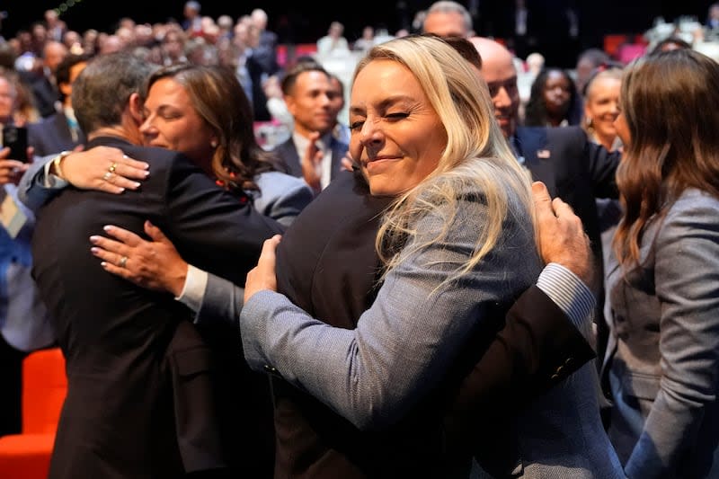 Former US skier Lindsey Vonn hugs members of the Salt Lake City delegation after the city was named Olympics host again as the IOC formally awarded the 2034 Winter Games to the United States bid, at the 2024 Summer Olympics, Wednesday, July 24, 2024, in Paris, France. | David Goldman