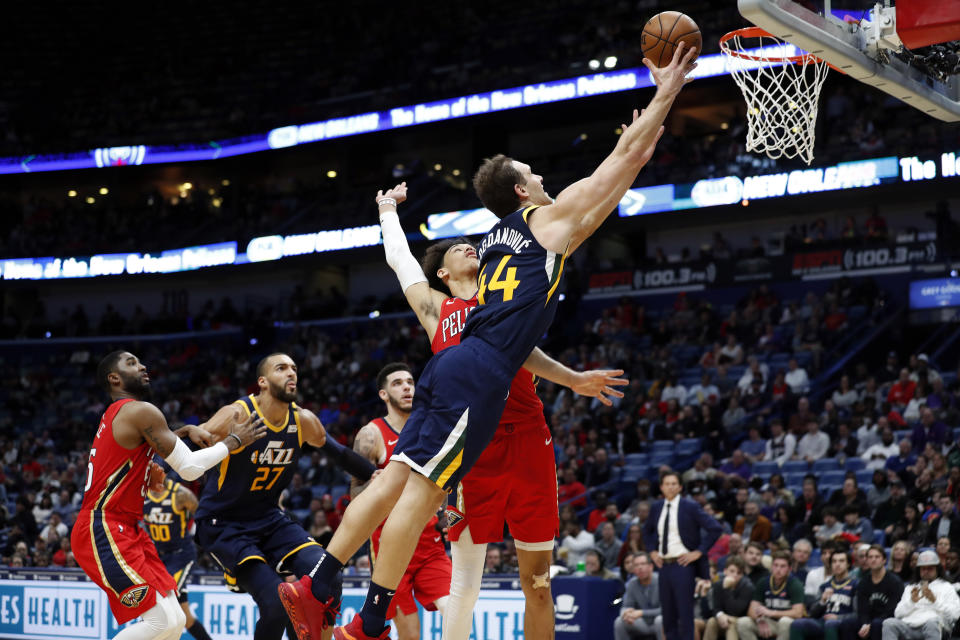 Utah Jazz forward Bojan Bogdanovic (44) drives to the basket in front of New Orleans Pelicans center Jaxson Hayes in the second half of an NBA basketball game in New Orleans, Monday, Jan. 6, 2020. (AP Photo/Tyler Kaufman)