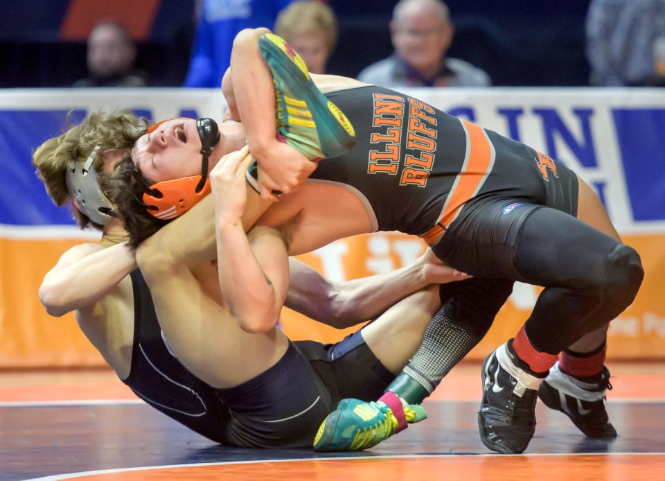 Illini Bluffs' Paul Ishikawa spins on Oakwood's Reef Pacot in the 145-pound title match of the  Class 1A state wrestling tournament Saturday, Feb. 18, 2023 at State Farm Arena in Champaign.