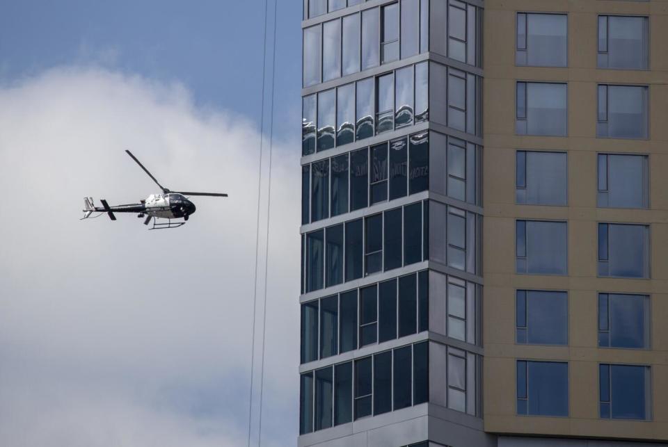 A Los Angeles Police helicopter flies over downtown Los Angeles