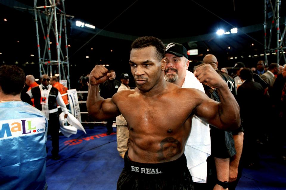 Mike Tyson strikes a traditional pose to celebrate his easy victory over Lou Savarese  (Photo by Jon Buckle/EMPICS via Getty Images)