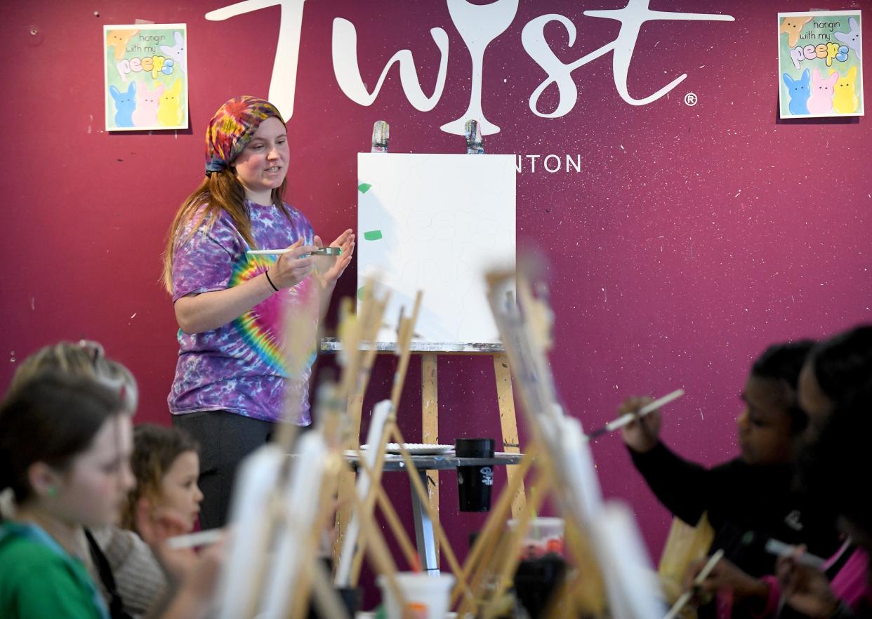 Instructor Emily Weil leads the class in an Easter-themed work of art at Painting with a Twist in North Canton.