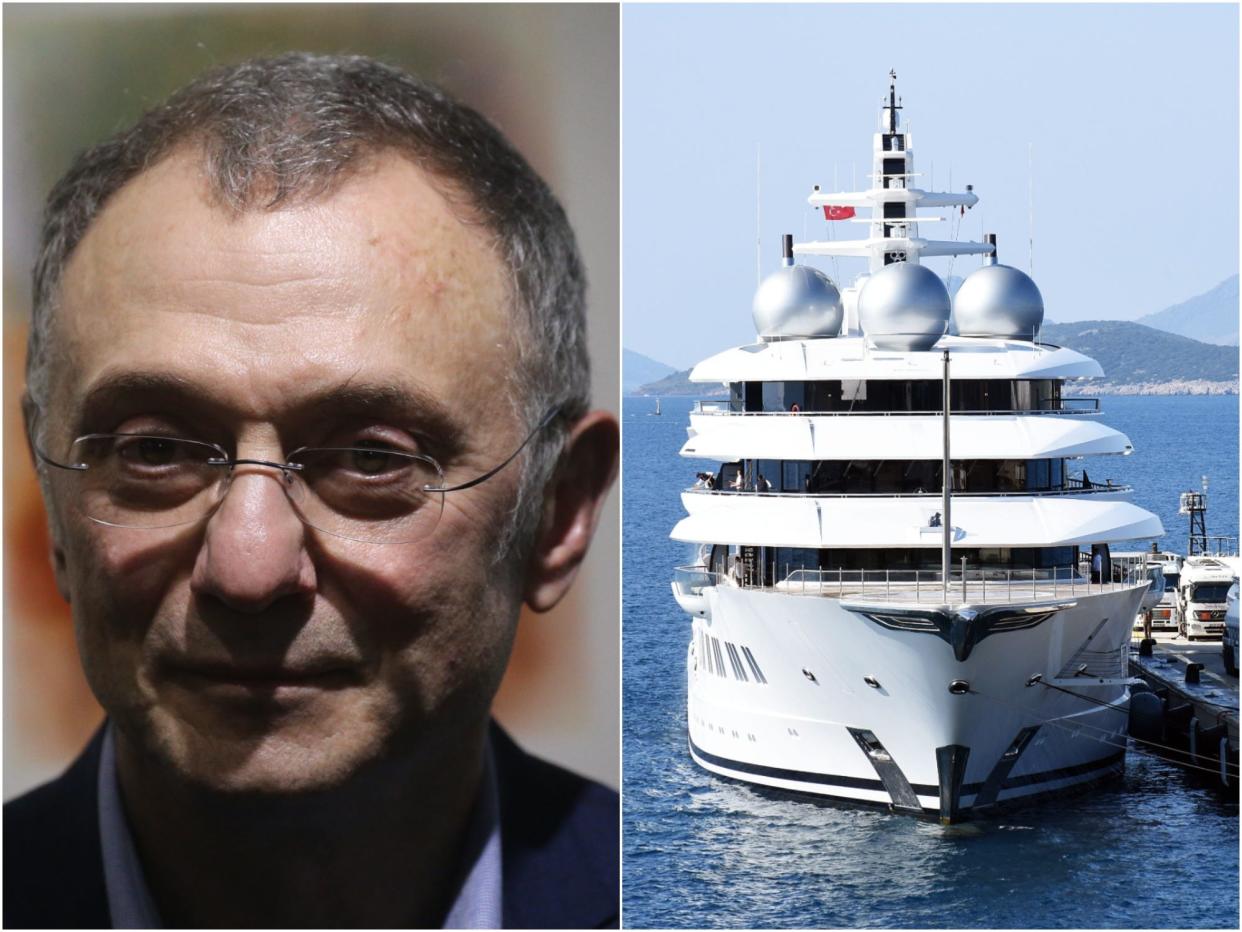 Suleyman Kerimov next to a picture of his $300 million superyacht Amadea