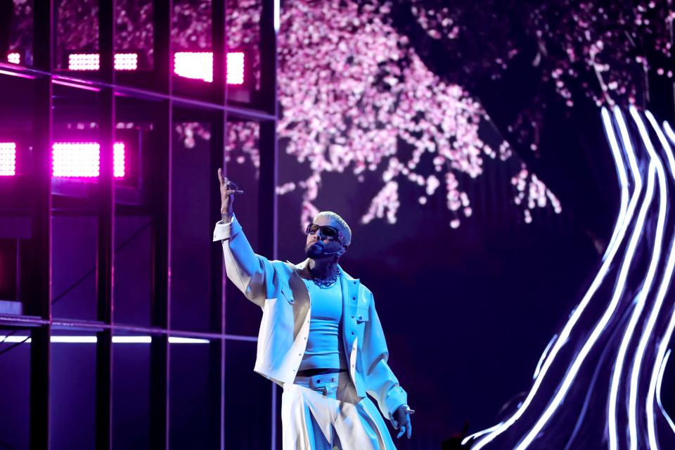 Rauw Alejandro performed in front of a light-up tree.