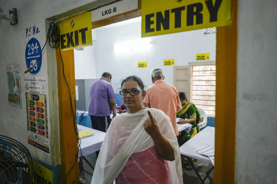 A woman shows the indelible ink mark on her index finger after casting vote in a polling station during the fourth phase of general election in Hyderabad, India, Monday, May 13, 2024. (AP Photo/Mahesh Kumar A.)