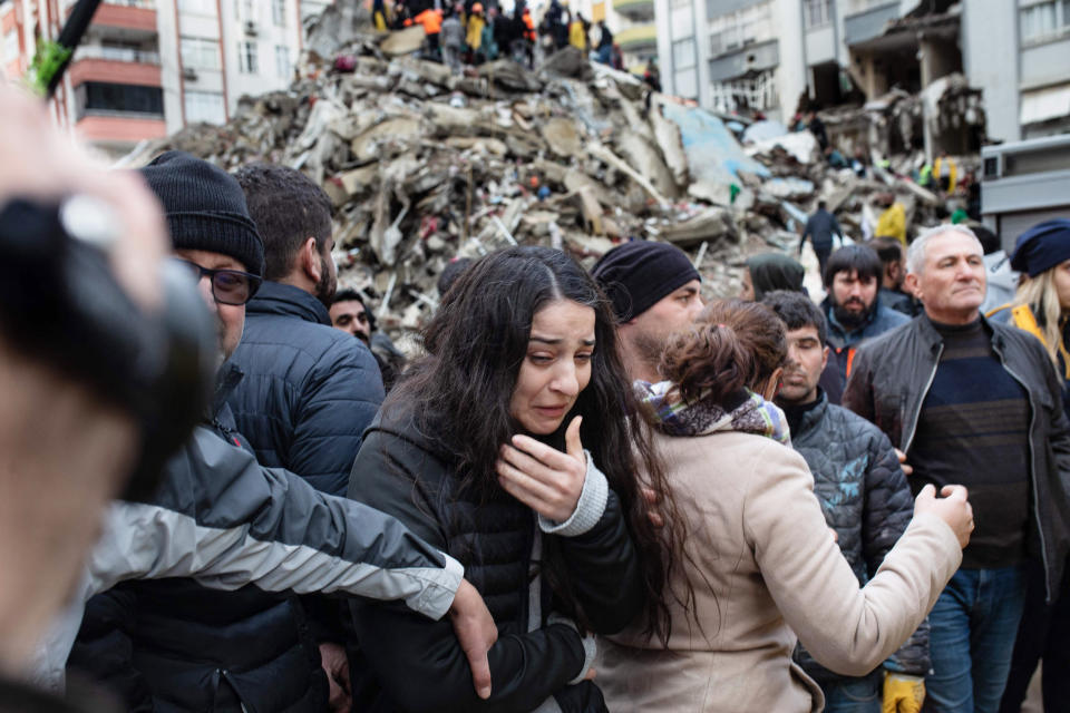 A woman reacts as rescuers search for survivors through the rubble  in Adana, Turkey, on Feb. 6, 2023.  (Can Erok / AFP - Getty Images)