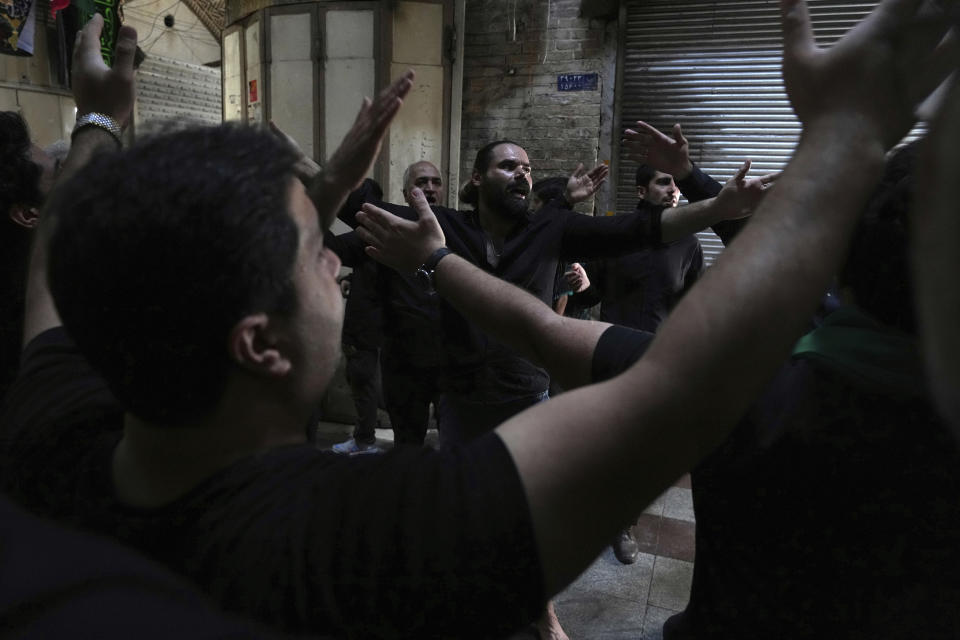 Mourners strike their chests during an annual procession commemorating Ashoura which marks the death anniversary of Imam Hussein, the grandson of Prophet Muhammad, in Tehran, Iran, Monday, Aug. 8, 2022. Some Shiite Muslims grieve by beating their backs with chains and flagellating themselves as a symbolic way of expressing their sadness of not being able to aid Imam Hussein, who was killed in the 7th century in the Battle of Karbala in present-day Iraq. (AP Photo/Vahid Salemi)