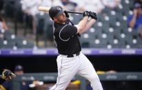 Colorado Rockies' C.J. Cron watches his grand slam off Milwaukee Brewers starting pitcher Brandon Woodruff during the first inning of a baseball game Thursday, June 17, 2021, in Denver. (AP Photo/David Zalubowski)