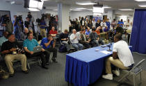 Kentucky's Julius Randle, bottom right, announces he will leave after one season to enter the NBA draft during a news conference in Lexington, Ky., Tuesday, April 22, 2014. (AP Photo/James Crisp)