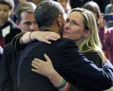 FILE - In this April 8, 2013, file photo, President Barack Obama embraces Scarlett Lewis, mother of Sandy Hook Elementary School shooting victim Jesse Lewis, after speaking at in Hartford, Conn. The pandemic is playing out in a divided country under a president who thrives on rousing his supporters and getting a rise out of those who don't like him, whether that means forgoing a mask, playing golf while millions hunker down or thrashing opponents on Twitter. (AP Photo/Susan Walsh, File)