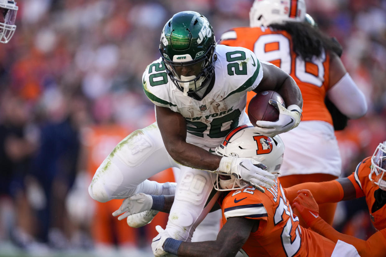 New York Jets running back Breece Hall is tackled by Denver Broncos safety Kareem Jackson during the second half of an NFL football game Sunday, Oct. 8, 2023, in Denver. (AP Photo/David Zalubowski)