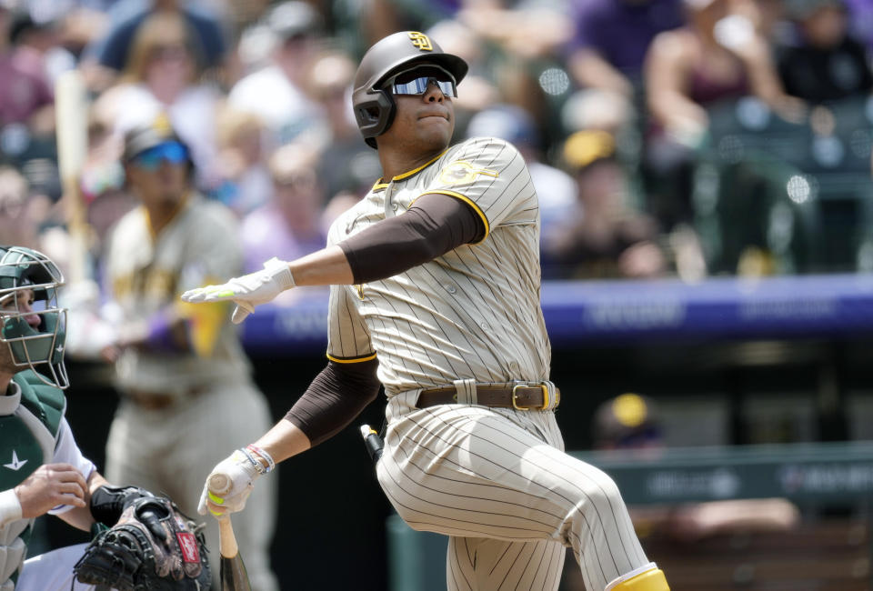 FILE - San Diego Padres' Juan Soto follows the flight of his two-run home run against Colorado Rockies starting pitcher Kyle Freeland in the third inning of a baseball game, Wednesday, Aug. 2, 2023, in Denver. Juan Soto, Vladimir Guerrero Jr. and Pete Alonso are among 194 players across Major League Baseball still negotiating salaries for the 2024 season leading into Thursday’s Jan. 11, 2024, deadline. (AP Photo/David Zalubowski, File)