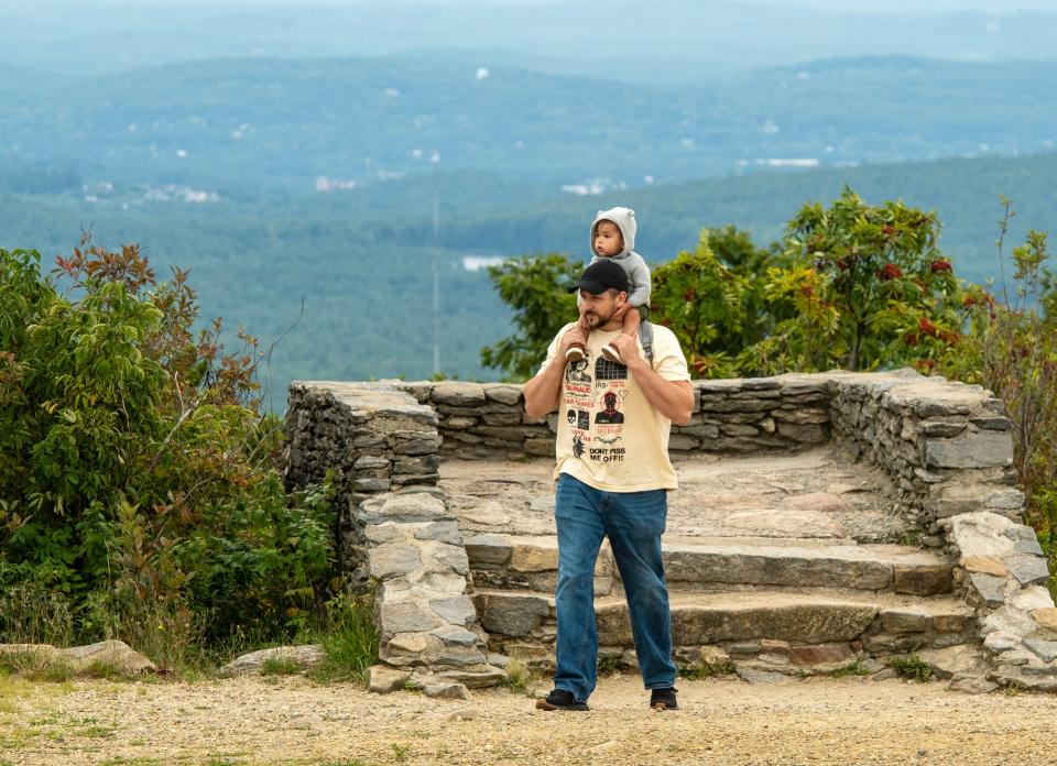 Daniel Reilly of Fitchburg walks around the 2,006-foot-high summit of Wachusett Mountain with his 1-year-old son Liam Thursday.