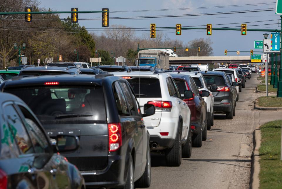 Dozens of vehicles wait at a traffic light on Ford Road in Canton on Tuesday, April 9, 2024. The Michigan Department of Transportation plans to spend $65 million to rebuild 2.5 miles of Ford Road.