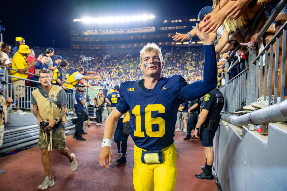 ANN ARBOR, MICHIGAN – AUGUST 31: Davis Warren #16 of the Michigan Wolverines interacts with fans as he leaves the field after a college football game against the Fresno St. Bulldogs at Michigan Stadium on August 31, 2024 in Ann Arbor, Michigan. The Michigan Wolverines won the game 30-10. (Photo by Aaron J. Thornton/Getty Images)